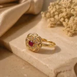 Gleaming red stone adjustable ring Pakistan with intricate gold cutwork and crystals