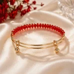 Red crystal bracelet Pakistan with elegant gold-tone cuff design