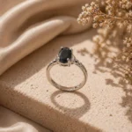 Adjustable black stone ring Pakistan with silver-tone band and oval crystal