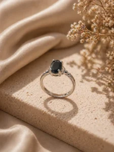 Adjustable black stone ring Pakistan with silver-tone band and oval crystal