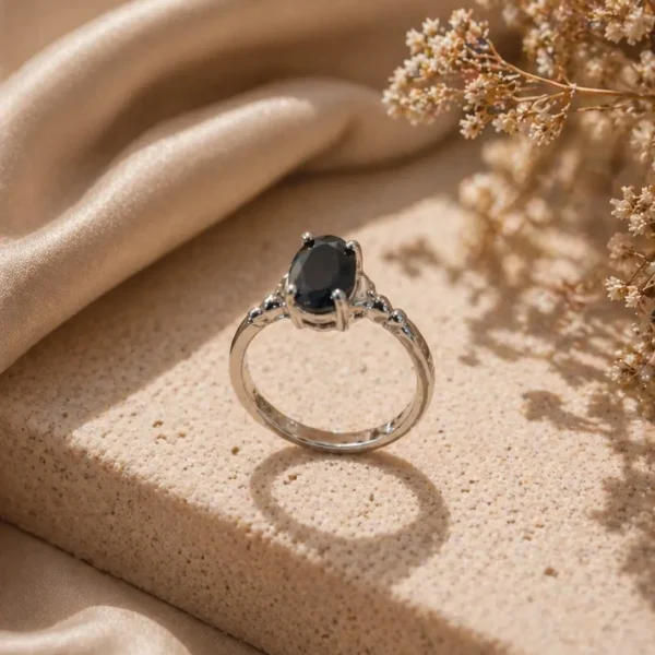 Adjustable black stone ring Pakistan with silver-tone band and oval crystal