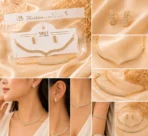 Gold-tone crystal necklace and matching stud earrings displayed on cream satin background