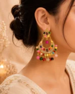 Woman wearing multicolor chandbali earrings with crystal and bead accents