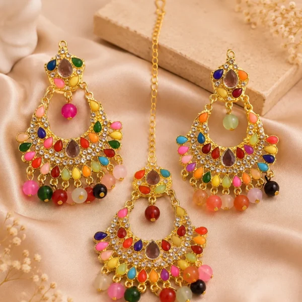 Gold-tone multicolor chandbali earrings with hanging bead detailing displayed on satin background