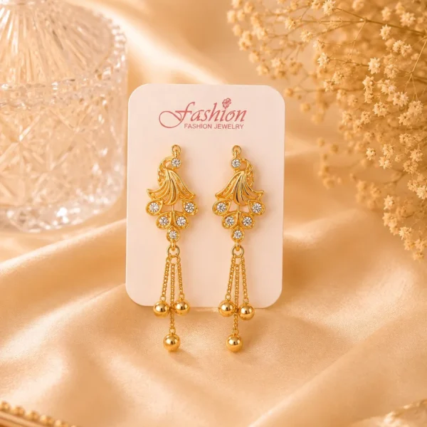 Gold-tone crystal tassel earrings displayed on jewelry card