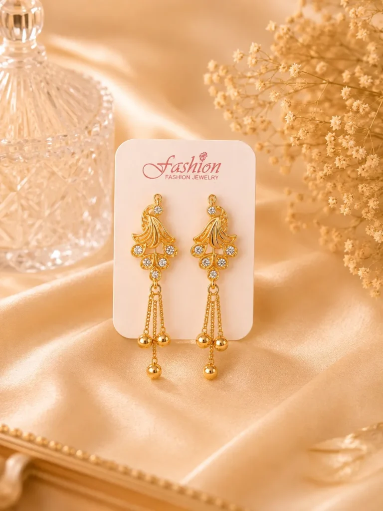 Gold-tone crystal tassel earrings displayed on jewelry card