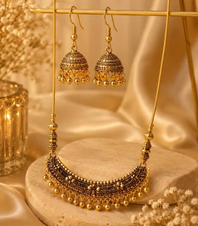 Antique gold necklace with matching jhumka earrings on display