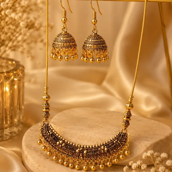 Antique gold necklace with matching jhumka earrings on display