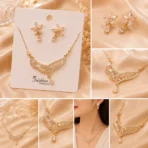 Gold plated crystal flower necklace set with matching earrings on jewelry card