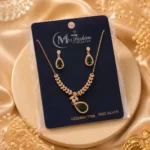 Gold plated green crystal necklace set displayed on luxury jewelry card