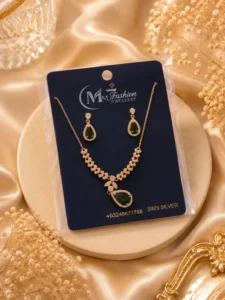 Gold plated green crystal necklace set displayed on luxury jewelry card