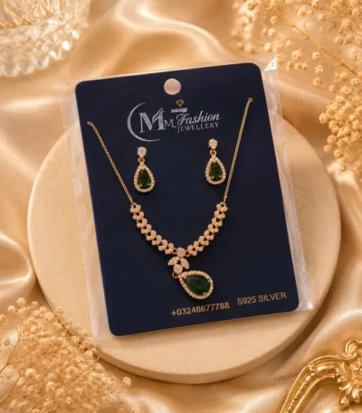 Gold plated green crystal necklace set displayed on luxury jewelry card