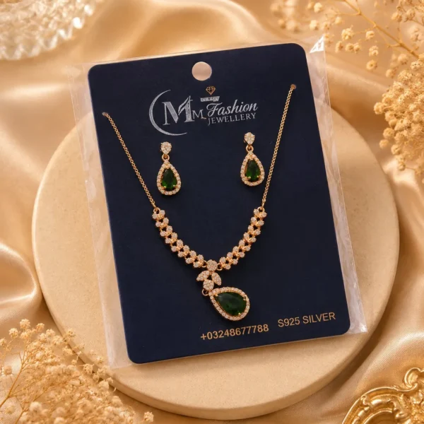 Gold plated green crystal necklace set displayed on luxury jewelry card