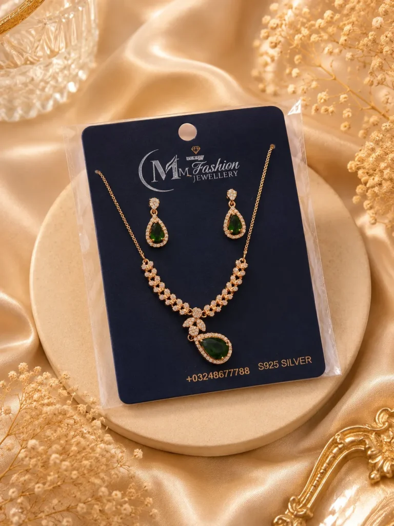 Gold plated green crystal necklace set displayed on luxury jewelry card