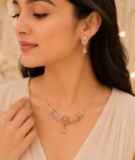 Woman wearing rose gold floral crystal necklace with matching earrings