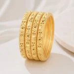 Gold textured bangles set Pakistan with engraved floral detailing