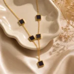 Black square lariat necklace gold with 5 enamel station tiles on cable chain worn by woman