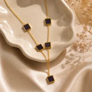 Black square lariat necklace gold with 5 enamel station tiles on cable chain worn by woman