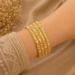 Diamond cut gold bangles Pakistan with floral engraving and 4-piece stack