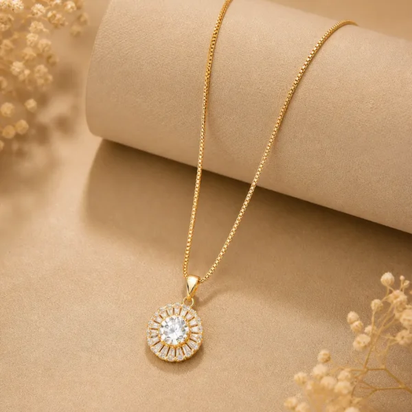 Gold halo pendant necklace with CZ baguette stones on box chain worn by woman