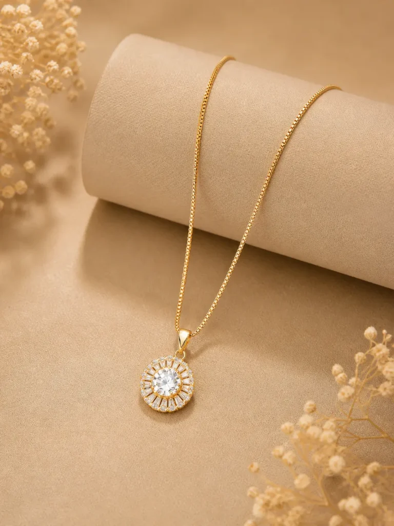 Gold halo pendant necklace with CZ baguette stones on box chain worn by woman