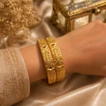 Two alluring gold plated floral bangles Pakistan style with traditional engraved details