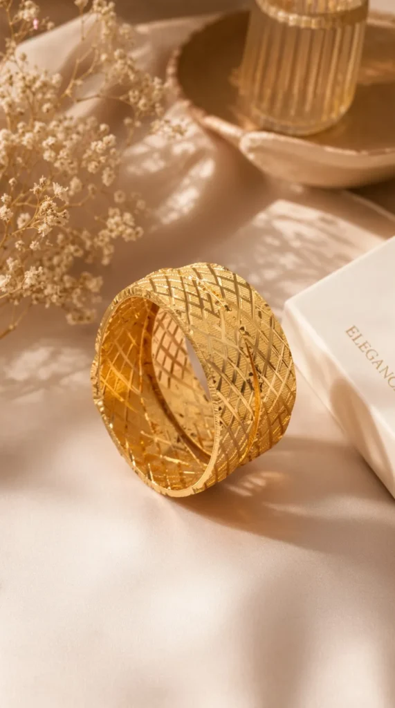 Wide gold bangle pair Pakistan — cross-engraved lattice kangan set worn on wrist by LumiraPK