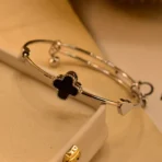 gold clover bracelet Pakistan with black luxury charm design