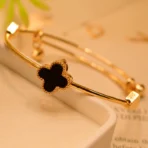 gold clover bracelet Pakistan with black luxury charm design