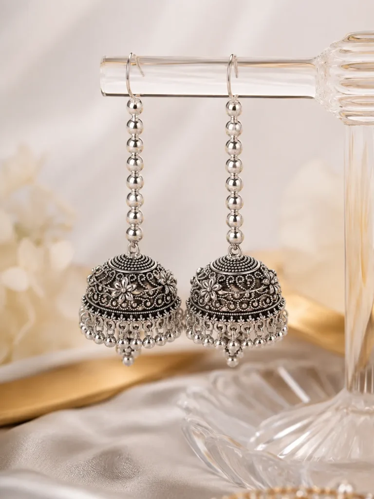 Silver oxidized long jhumka earrings for women with antique floral design and hanging beads for Pakistani ethnic wear