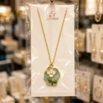Gold plated floral pearl pendant necklace with blue enamel flower design for women in Pakistan