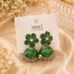 Green jhumka earrings Pakistan featuring emerald floral studs, crystal accents, and traditional silver-tone jhumka design by Lumira PK