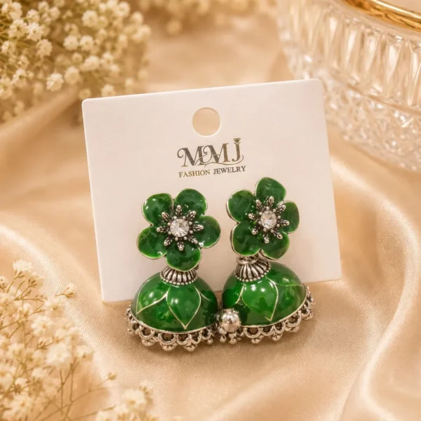 Green jhumka earrings Pakistan featuring emerald floral studs, crystal accents, and traditional silver-tone jhumka design by Lumira PK