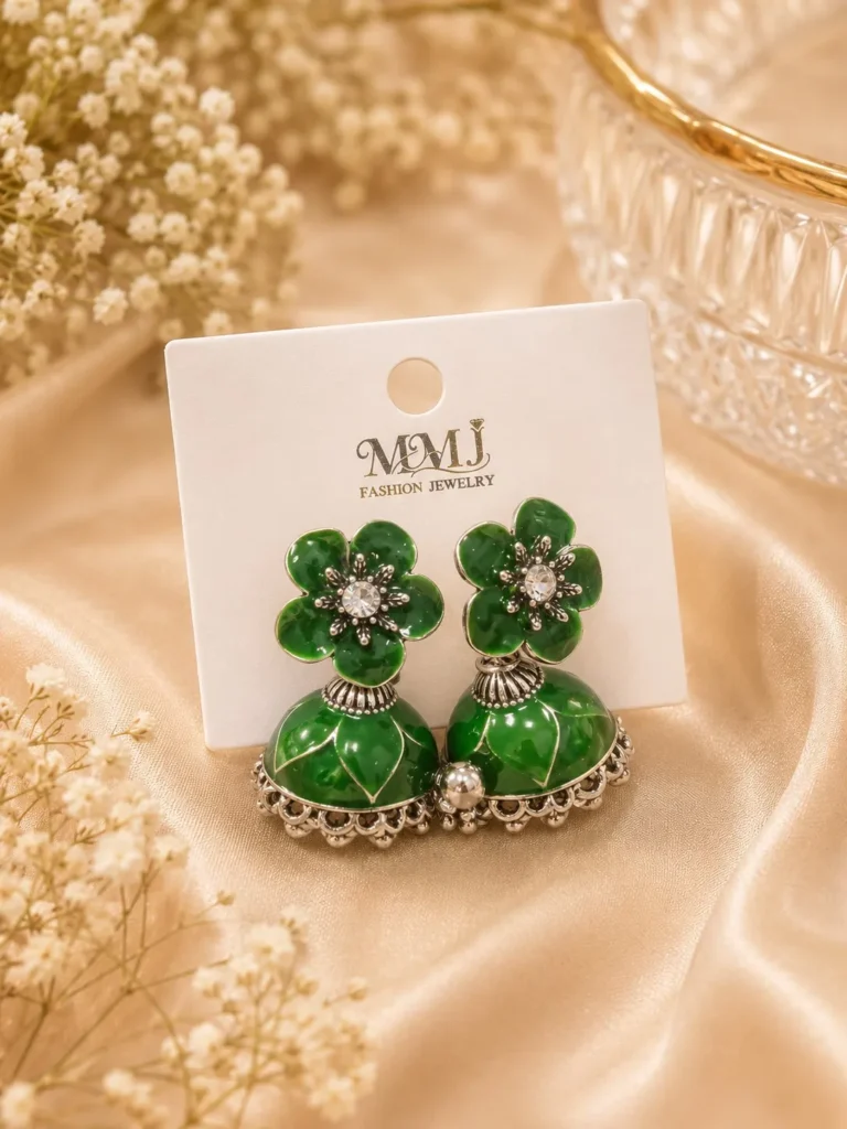 Green jhumka earrings Pakistan featuring emerald floral studs, crystal accents, and traditional silver-tone jhumka design by Lumira PK