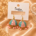 Pastel jhumka earrings Pakistan with pink and turquoise enamel detailing, gold accents, and pink bead drops by Lumira PK