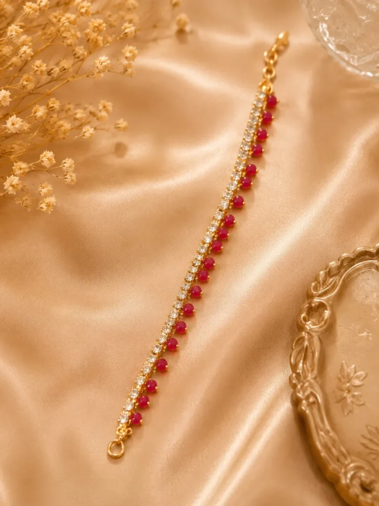 Ruby crystal anklet with red bead accents and sparkling crystal stones on a gold-tone chain by Lumira PK Pakistan
