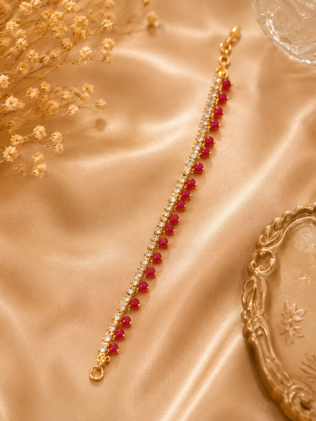 ruby-crystal-anklet-pakistan-lumira-pk.webp Ruby crystal anklet with red bead accents and sparkling crystal stones on a gold-tone chain by Lumira PK Pakistan