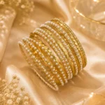 Pearl bangle set with gold-tone finish and layered pearl detailing for women in Pakistan by Lumira PK
